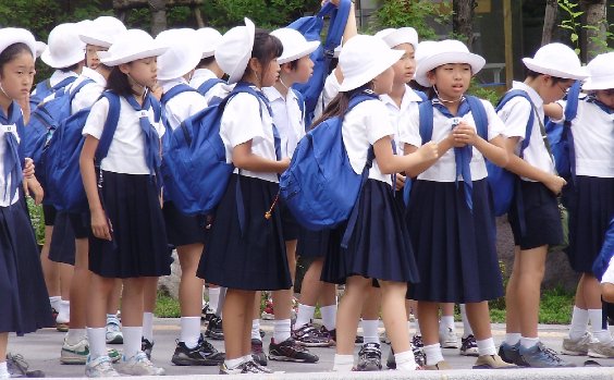 Kinder in Japan in Schuluniform warten auf den Bus